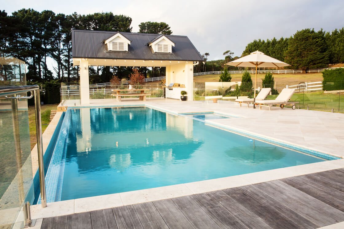 Spacious luxury pool with poolhouse and loungers on a rural property