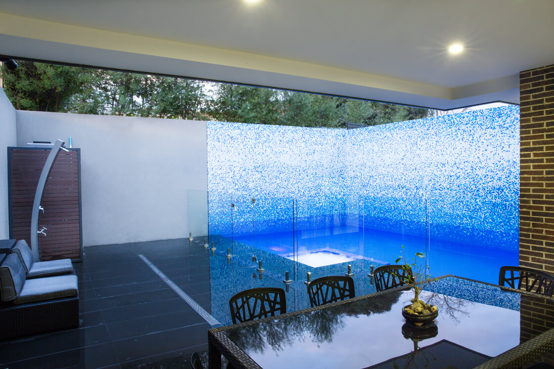 Plunge pool with mosaic tiled wall and outdoor entertaining area