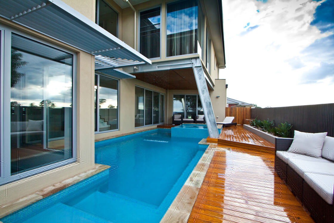 Lap pool in courtyard under cantilevered home extension